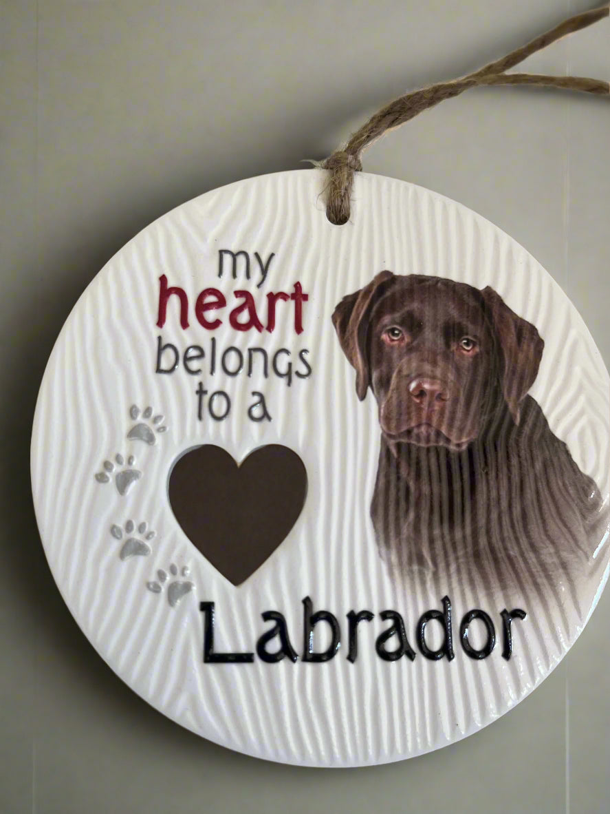 Round wooden plaque with a chocolate Labrador and text 'my heart belongs to a Labrador' on a white background.