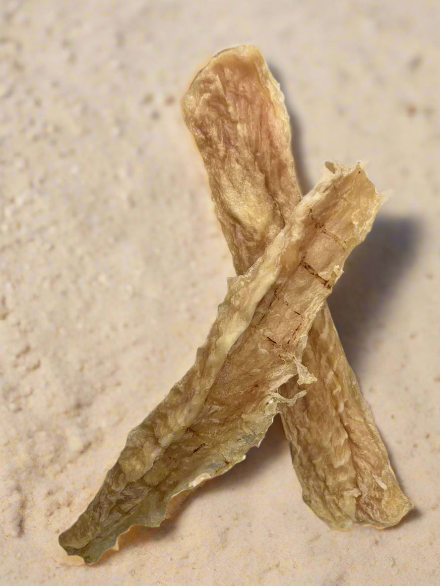 Dried Strips of Fish on a gray background