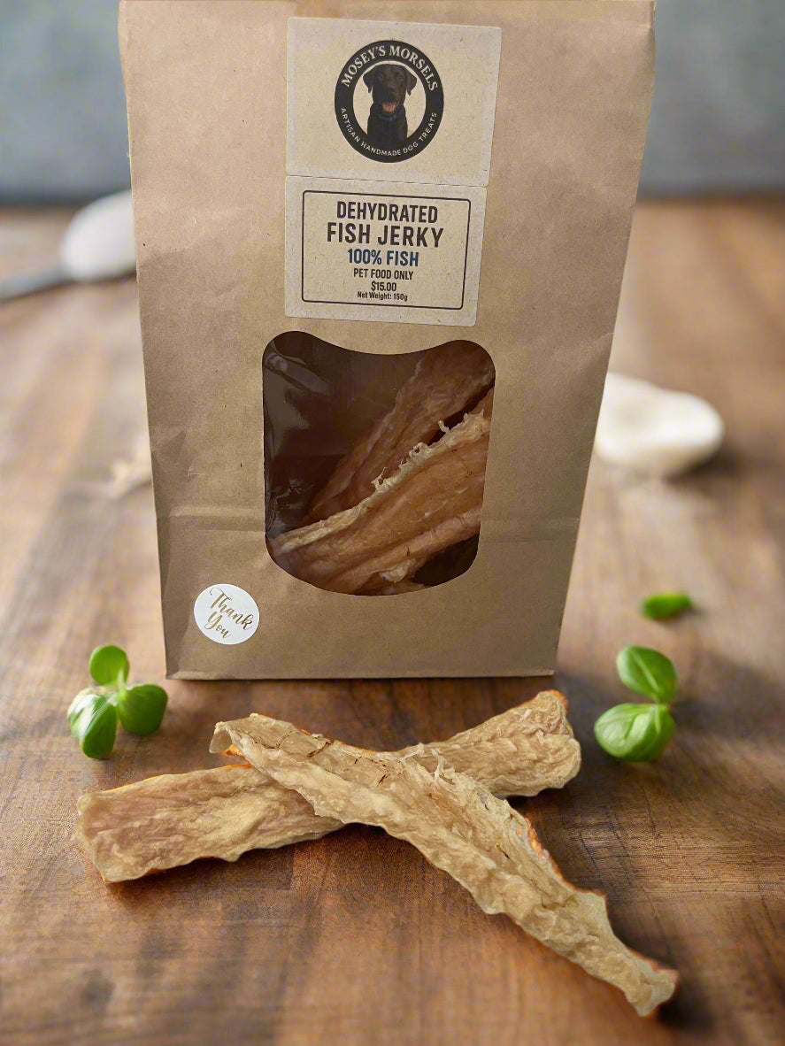 Kraft paper bag of dehydrated fish jerky with a visible piece on a gray surface