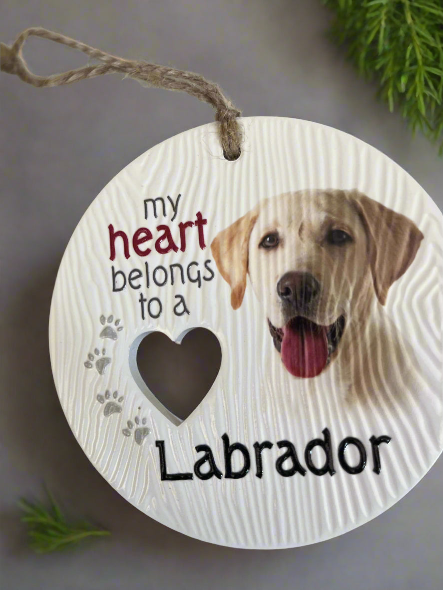 Round wooden sign with a Labrador dog illustration and text 'my heart belongs to a Labrador' on a white background.