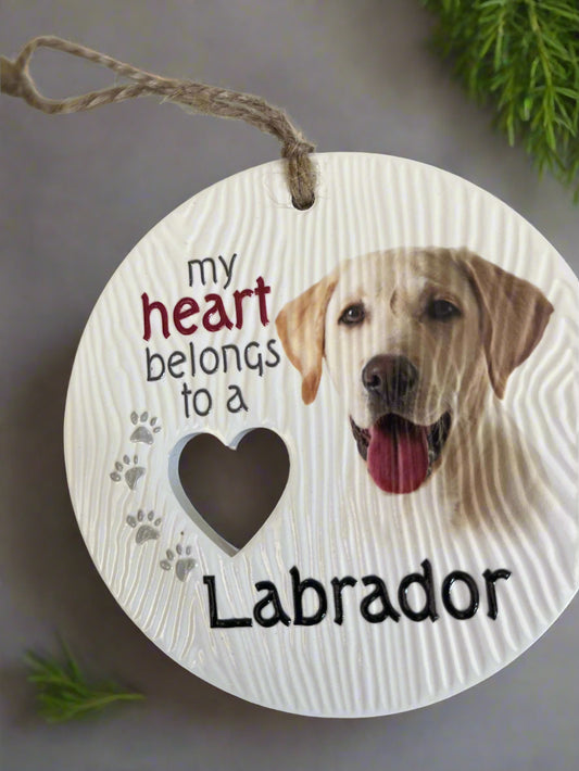 Round wooden sign with a Labrador dog illustration and text 'my heart belongs to a Labrador' on a white background.